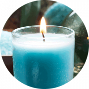 lit blue candle in glass jar