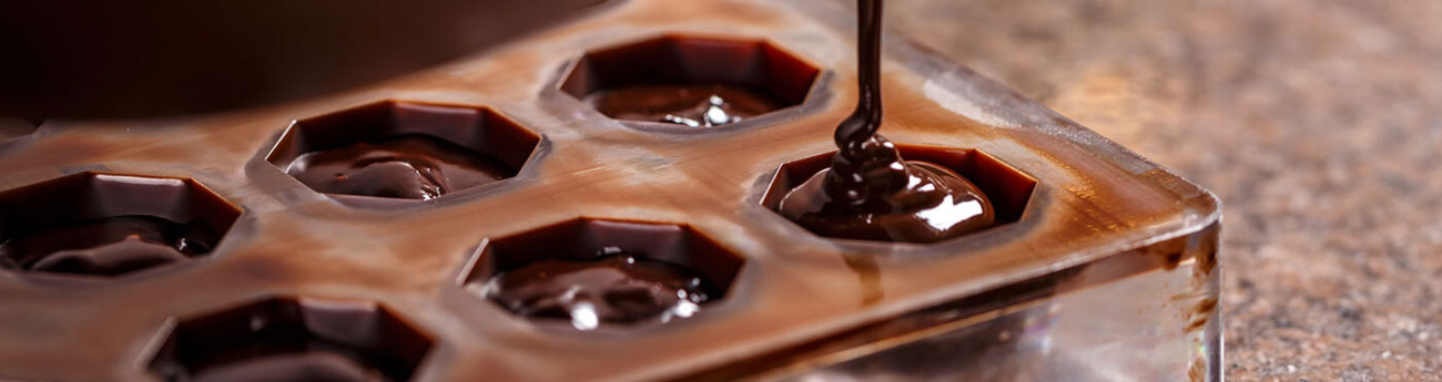 chocolate molds being filled